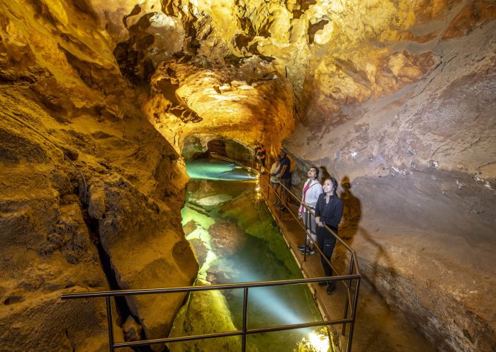 Small group enjoying a tour through the River Cave system at Jenolan Caves in the Blue Mountains