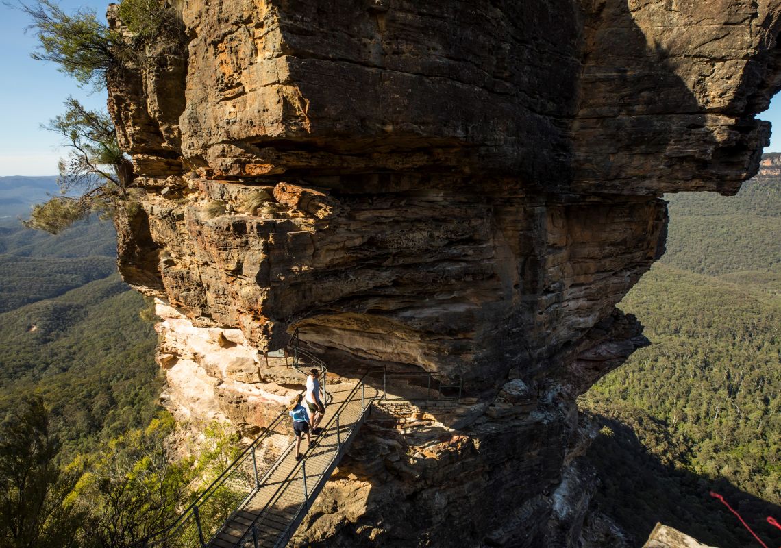 Couple enjoying views from Honeymoon Bridge overlooking the Jamison Valley along the Three Sisters Walking Trail, Katoomba.