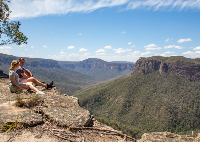 Couple enjoying views of the Grose Valley, Blackheath along the Grand Canyon Walking Track, Blue Mountains