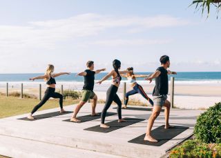 Elements of Byron guests enjoying morning beachfront yoga sessions, Byron Bay